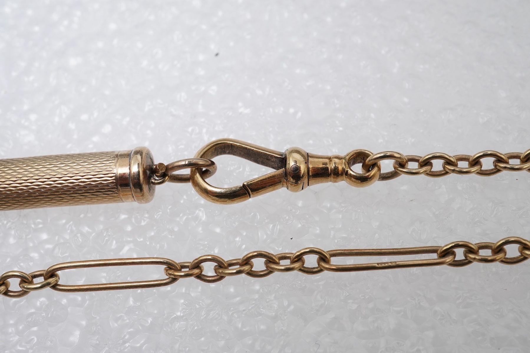 A gold watch chain, toothpick and fob seal